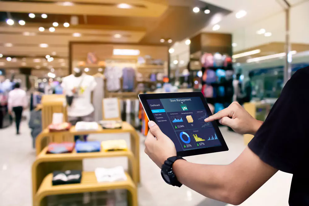 Manager using digital tablet in a retail store.