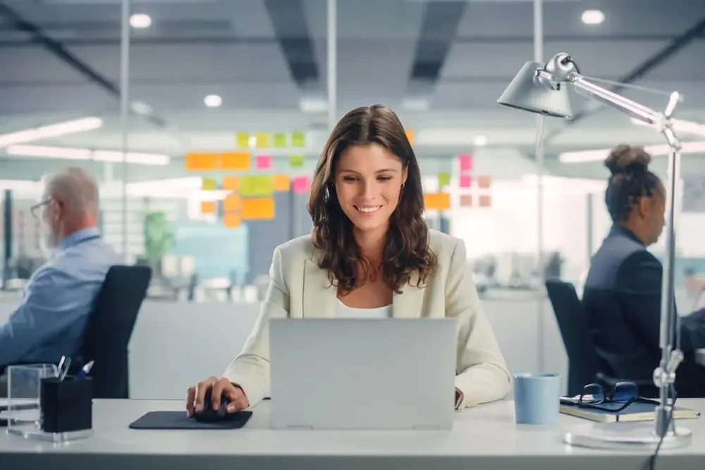 Young, smiling businesswoman working on  Project Portfolio Management in modern office.